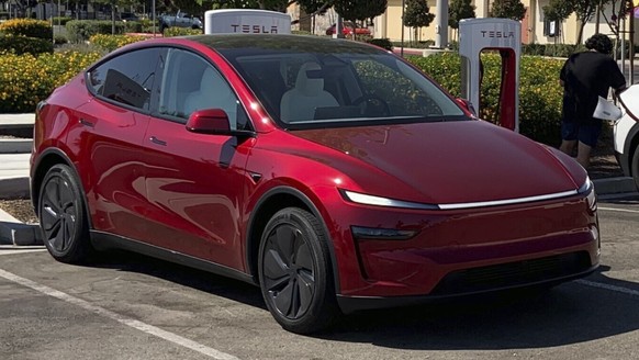 This photo provided by Edmunds shows a Tesla Model Y and a Kia EV6 parked at a Tesla Supercharger station in Fresno, Calif. Planning a cross-country trip in an EV takes extra effort, but doing it prop ...