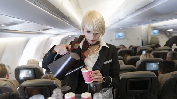 A flight attendant attends to the passengers of the Economy Class, pictured on April 29, 2013 in an aircraft of Swiss. Swiss, short for Swiss International Air Lines, flies from Zurich to Chicago and  ...