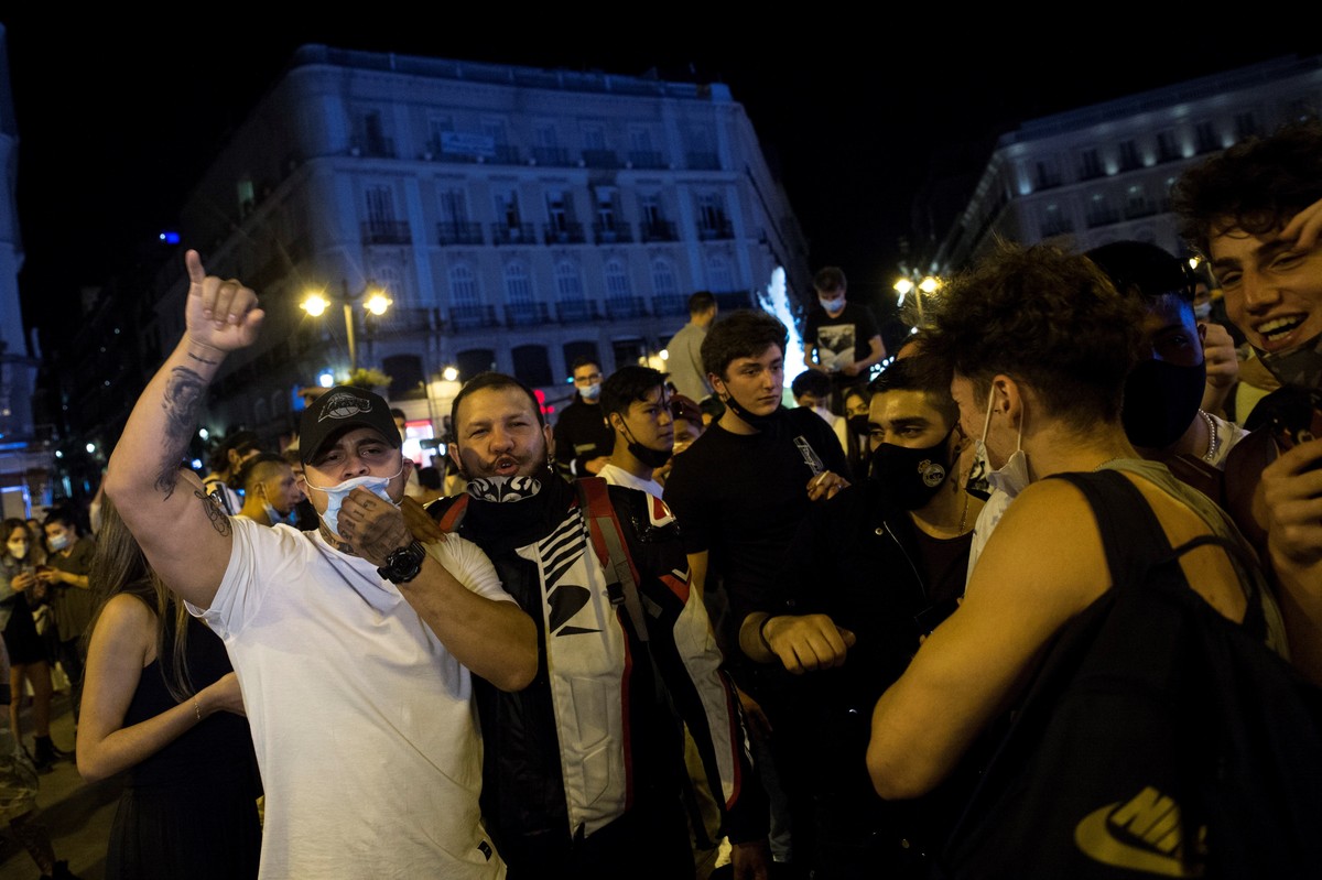 epa09186700 Hundreds of people celebrate in people celebrate in Madrid's Puerta del Sol, Spain, 08 May 2021. The state of alarm that was imposed six month ago due to the pandemic expires on 09 Ma ...