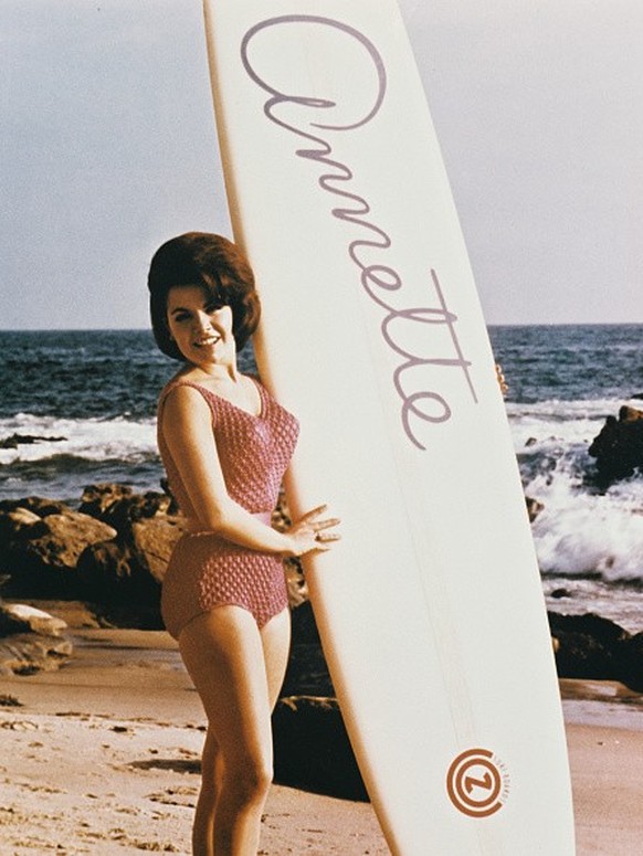 American actress and singer Annette Funicello (1942 - 2013) poses with a surfboard with her name on it, circa 1965. (Photo by Silver Screen Collection/Getty Images)