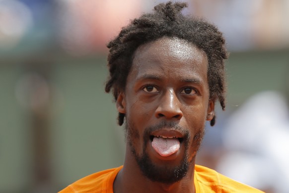 France&#039;s Gael Monfils sticks out his tongue as he plays against France&#039;s Richard Gasquet during their third round match of the French Open tennis tournament at the Roland Garros stadium, in  ...