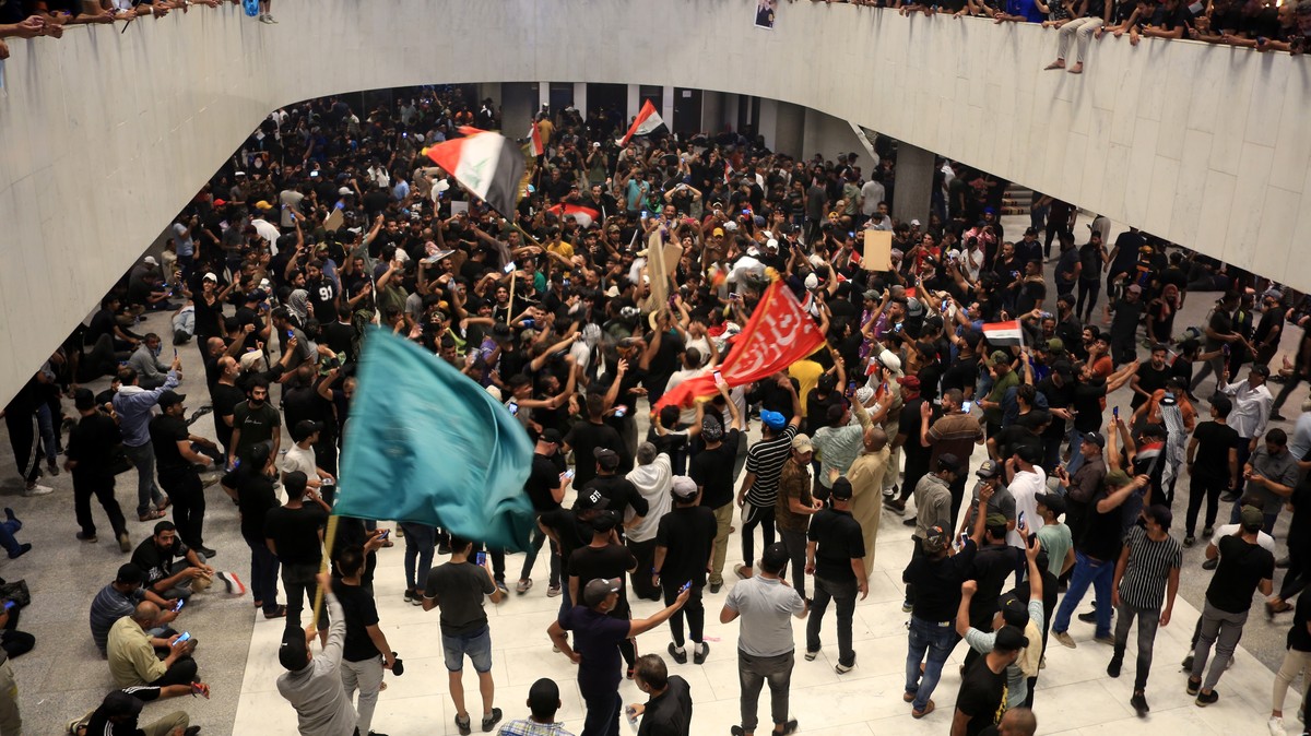 epa10098624 Supporters of Iraqi Shiite cleric Muqtada al-Sadr, head of the Sadrist movement, gather inside the Iraqi parliament building after they stormed the 'Green Zone' in central Baghda ...