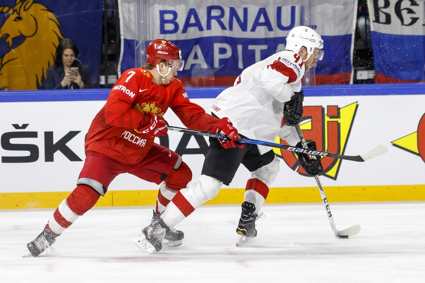 Russia&#039;s forward Kirill Kaprizov, left, vies for the puck with Switzerland&#039;s defender Mirco Mueller, right, during the IIHF 2018 World Championship preliminary round game between Russia and  ...
