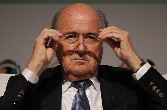 FIFA President Sepp Blatter puts on his glasses as he prepares to speak about the World Cup&#039;s impact on Brazilian soccer, during a sports management seminar at the Maison de France theater in dow ...