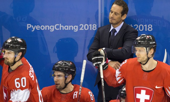 Tristan Scherwey of Switzerland, Simon Moser of Switzerland, Patrick Fischer, head coach of Switzerland, and Simon Bodenmann of Switzerland, from left, react after the men ice hockey play-off qualific ...