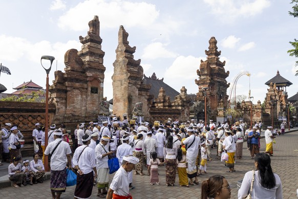 epa12048104 People attend Galungan prayer at a temple in Denpasar, Bali, Indonesia, 23 April 2025. Galungan is a major Balinese Hindu festival, symbolizing the triumph of good over evil and commemorat ...