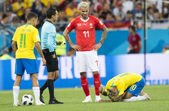 Brazil&#039;s midfielder Philippe Coutinho, left, Switzerland&#039;s midfielder Valon Behrami, center, react next to Brazil&#039;s forward Neymar, right, during the FIFA soccer World Cup 2018 group E  ...