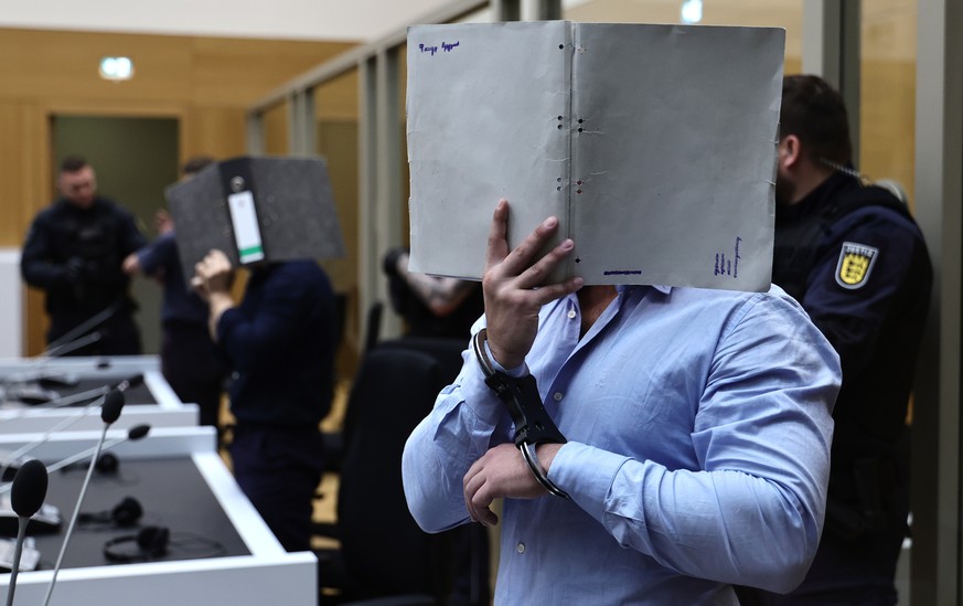epa13176849 Ukrainian defendants stand before the court during his trial at the Higher Regional Court in Stuttgart, Germany, 18 August 2026. According to the German Federal Prosecutor's Office, t ...