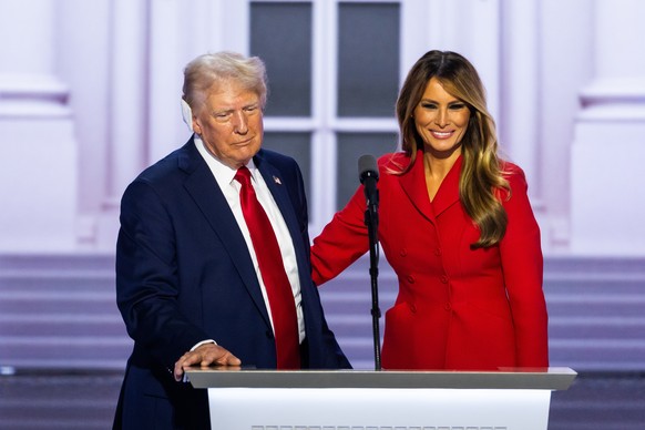 epa11486849 Republican presidential nominee and former President Donald Trump and former First Lady Melania Trump (R), celebrate after he delivered remarks during the last day of the Republican Nation ...