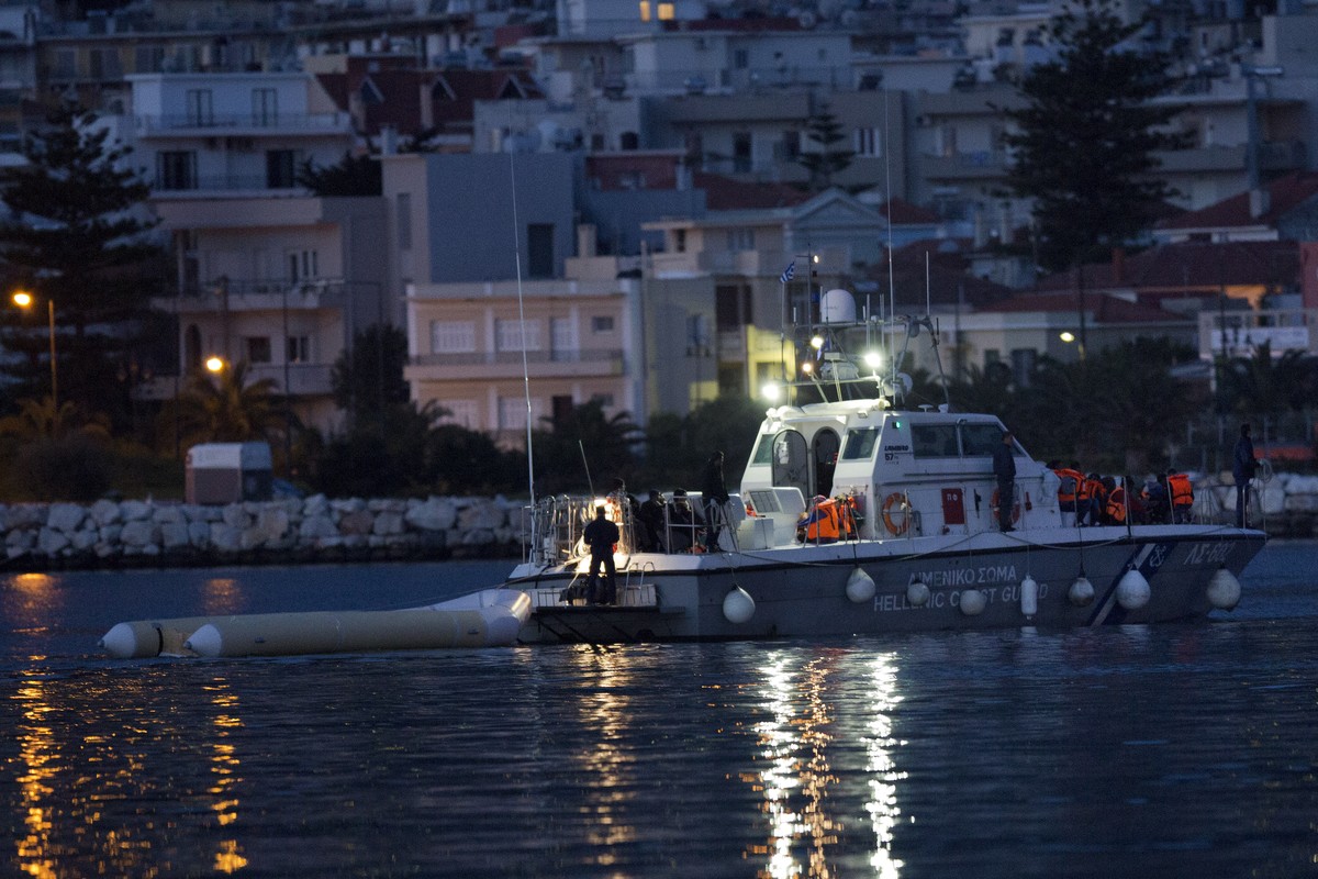 A Greek Coast guard vessel carries migrants and refugees after a rescue operation in the Aegean sea near the shores of Lesbos island Monday, April 4, 2016, during the first day of the implementation o ...