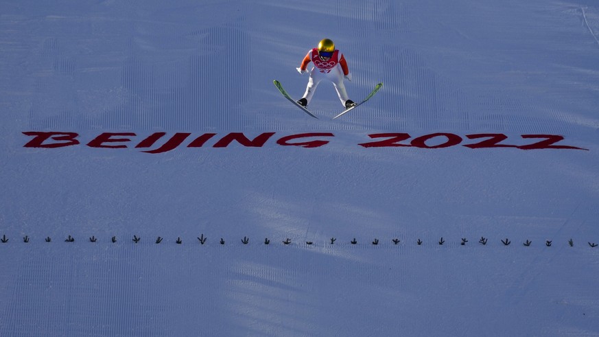 Simon Ammann, of Switzerland, soars through the air during the men&#039;s normal hill individual ski jumping qualification round at the 2022 Winter Olympics, Saturday, Feb. 5, 2022, in Zhangjiakou, Ch ...