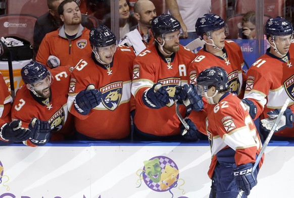 Florida Panthers center Denis Malgin (62) is congratulated by teammates after scoring a goal against the New Jersey Devils during the second period of an NHL hockey game, Thursday, Nov. 3, 2016, in Su ...