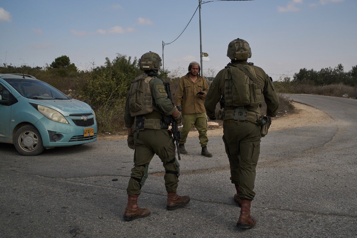 An Israeli settler speaks with Israeli soldiers during the Palestinian olive harvest in a valley in the West Bank town of Birzeit, Friday, Oct. 9, 2026. (AP Photo/Leo Correa)
Israel Palestinians West  ...