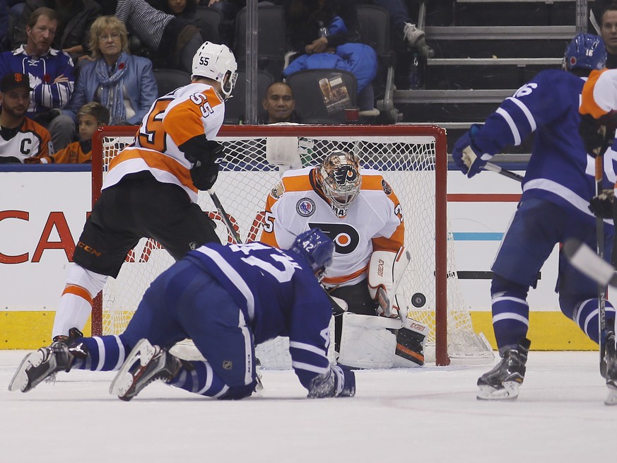 Nov 11, 2016; Toronto, Ontario, CAN; Toronto Maple Leafs forward Mitchell Marner (right) scores on Philadelphia Flyers goaltender Steve Mason (35) at the Air Canada Centre. Toronto defeated Philadelph ...