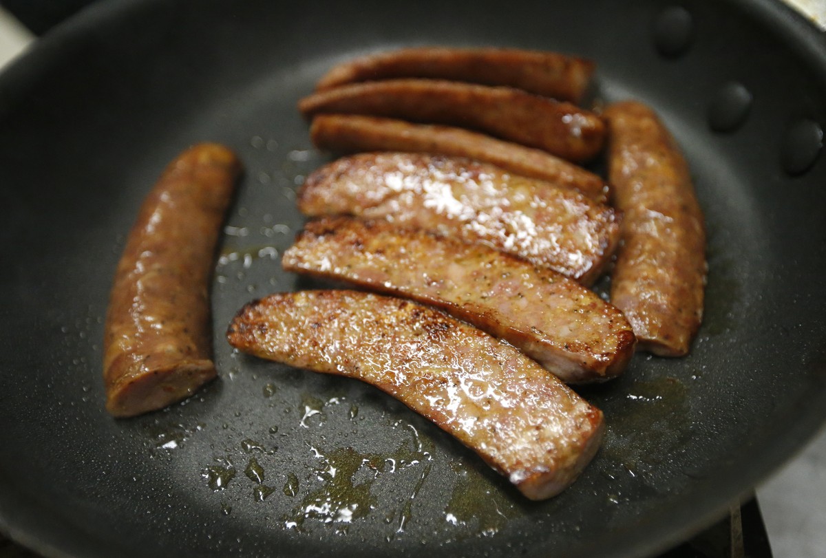 In this March 21, 2017 photo, a sample of wild boar sausage simmers in a frying pan at the Springfield Slaughterhouse in Springfield, La. The small Louisiana slaughterhouse has a big mission: getting  ...