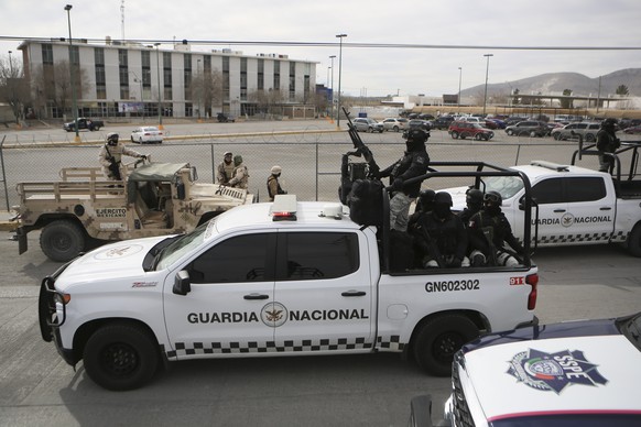 Mexican National Guard stands guard outside a state prison in Ciudad Juarez, Mexico, Sunday, January 1, 2023. Mexican soldiers and state police regained control of a state prison in Ciudad Juarez across the street from…