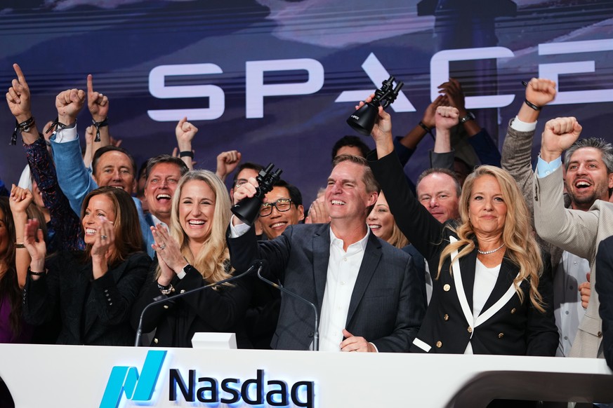 Gwynne Shotwell, President and COO of SpaceX, right, celebrates with colleagues during a bell ringing ceremony for the IPO of SpaceX at the Nasdaq MarketSite in New York, Friday, June 12, 2026, in New ...