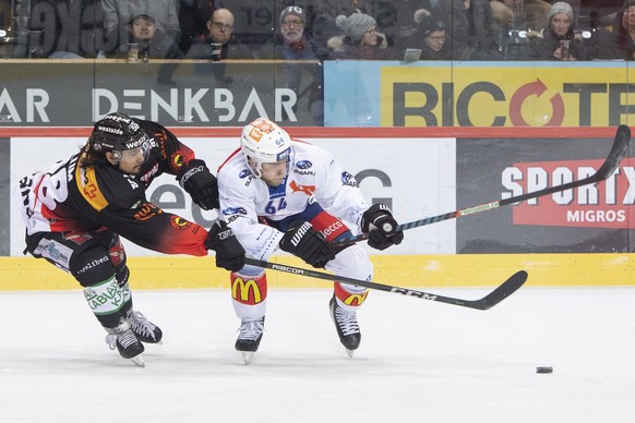 Berns Eric Blum, links, und Zuerichs Stuermer Victor Backman, rechts, kaempfen um den Puck, beim Eishockey Meisterschaftsspiel der National League zwischen dem SC Bern und den ZSC Lions, in der Postfi ...