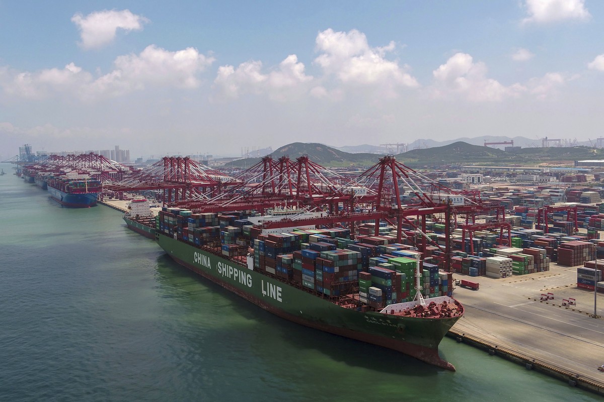 In this Aug. 6, 2019, photo, a container ship is docked a port in Qingdao in eastern China's Shandong province. U.S. President Donald Trump angrily escalated his trade fight with China on Friday, ...