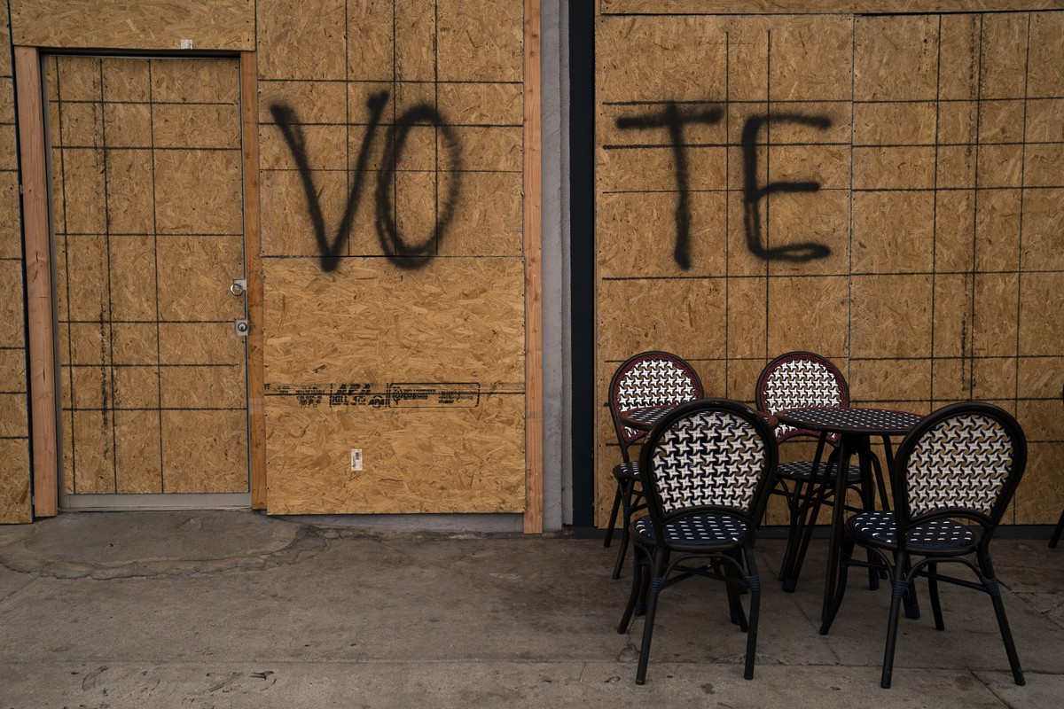 The word "Vote" is spray painted on plywood of a boarded-up store on Election Day Tuesday, Nov. 3, 2020, in Los Angeles. The scourge of a global pandemic produced an election season like no  ...