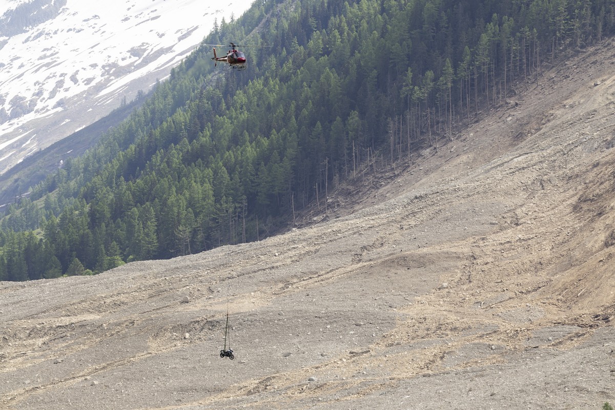 A helicopter flies over the landslide a few days after a massive avalanche, triggered by the collapse of the Birch Glacier, shows the destruction it caused as it swept down to the valley floor and dem ...
