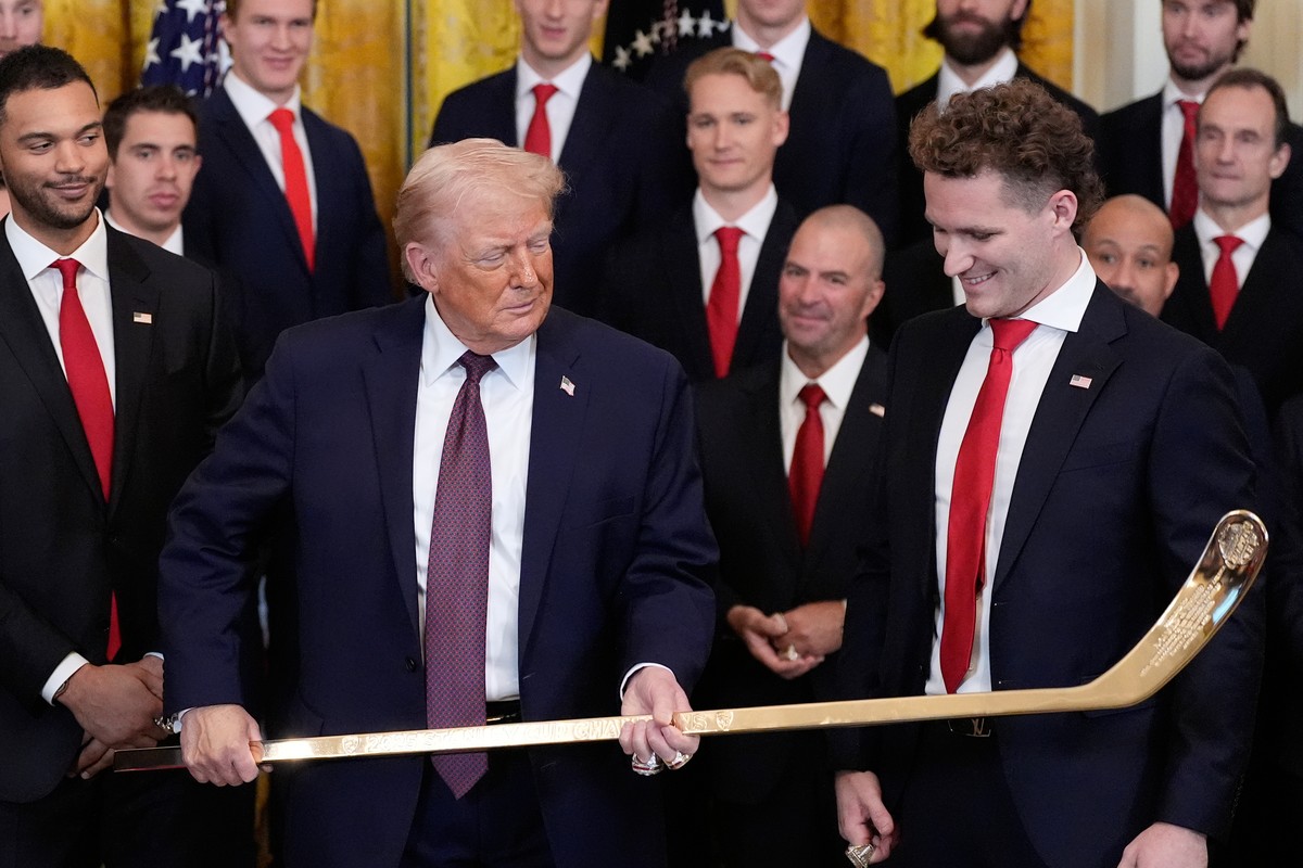 President Donald Trump holds a hockey stick presented to him by Matthew Tkachuk during an event to honor the 2025 Stanley Cup Champion Florida Panthers in the East Room of the White House, Thursday, J ...