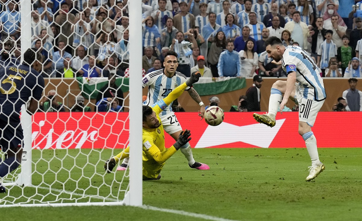 Argentina's Lionel Messi, right, scores his side's third goal during the World Cup final soccer match between Argentina and France at the Lusail Stadium in Lusail, Qatar, Sunday, Dec. 18, 20 ...