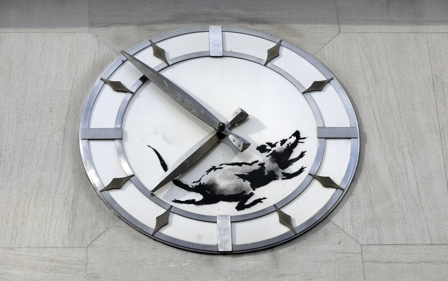 epaselect epa06606934 A new street art work by Banksy, the anonymous British street artist is of a rat In the inner portion of a clock above a closed former bank building on 14th Street and 6th Avenue ...