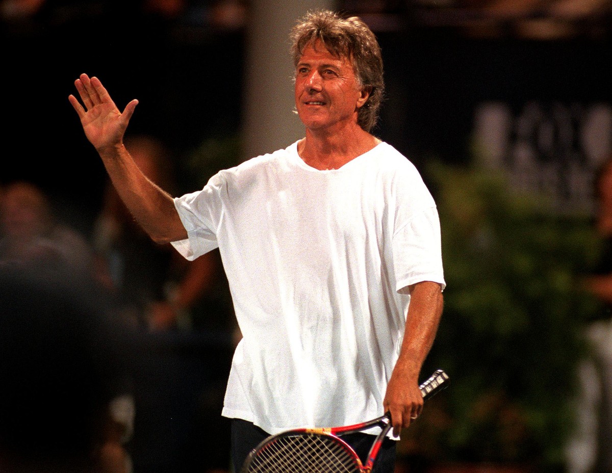 373929 16: Actor Dustin Hoffman waves to the crowd as he competes in the 9th Annual "A Night at the Net" celebrity tennis match to benefit Musicares July24, 2000 at UCLA, Westwood, CA. (Phot ...