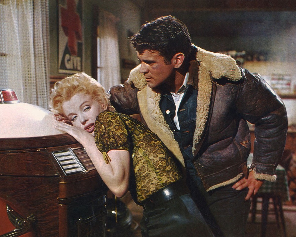 Marilyn Monroe leans against vintage jukebox as Don Murray stands over her in a scene from 'Bus Stop' 1956. (Photo by Screen Archives/Getty Images)