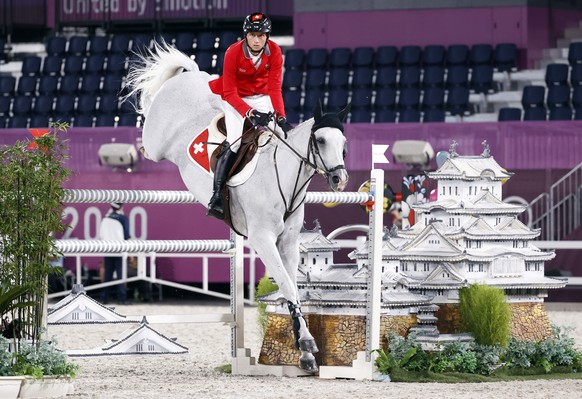 epa09394269 Martin Fuchs of Switzerland on Clooney 51 competes in the Jumping Individual Final during the Equestrian events of the Tokyo 2020 Olympic Games at the Baji Koen Equestrian Park in Setagaya ...