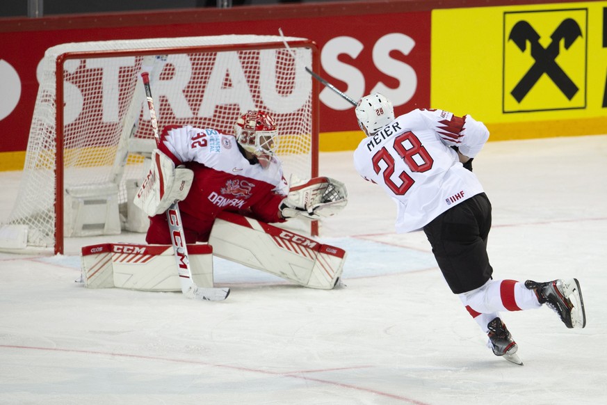 epa09223720 Denmark&#039;s goaltender Sebastian Dahm (L) blocks a puck shooting from Switzerland&#039;s forward Timo Meier during the IIHF 2021 World Championship Group A match between Denmark and Swi ...