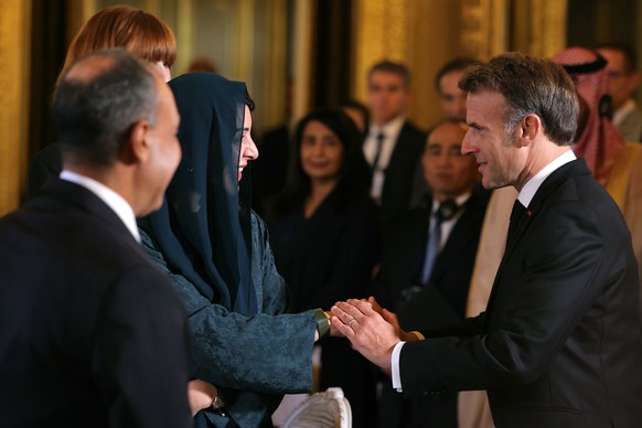 epa12442311 France&#039;s President Emmanuel Macron greets Emirati Minister of State for International Cooperation Reem Ebrahim Al-Hashimi (L) during a Ministerial meeting on the implementation of the ...