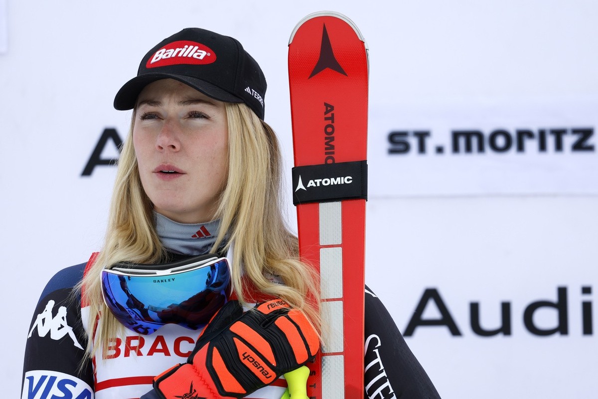 United States' Mikaela Shiffrin, winner of an alpine ski, women's World Cup downhill race, listens to the national anthem as she stands on the podium, in St. Moritz, Switzerland, Saturday, D ...