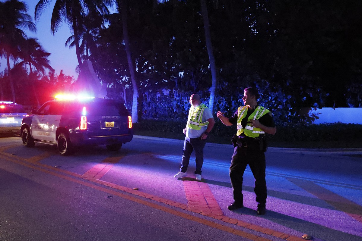 Police direct traffic outside an entrance to former President Donald Trump's Mar-a-Lago estate, Monday, Aug. 8, 2022, in Palm Beach, Fla. Trump said in a lengthy statement that the FBI was conduc ...