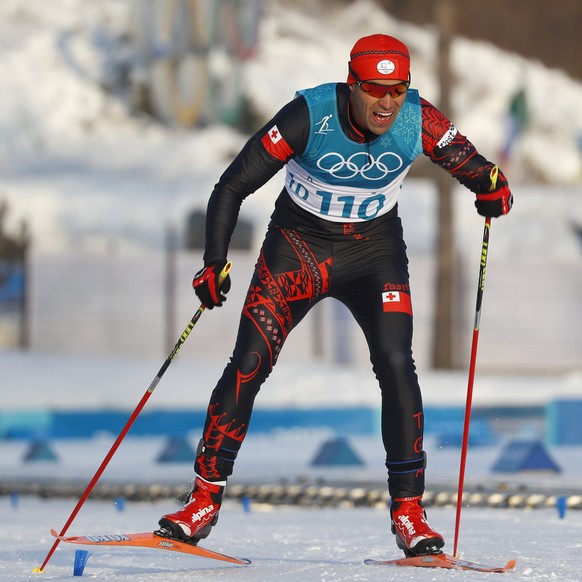 epa06531612 Pita Taufatofua of Tonga approaches the finish line of the Men's Cross Country 15 km Free race at the Alpensia Cross Country Centre during the PyeongChang 2018 Olympic Games, South Ko ...