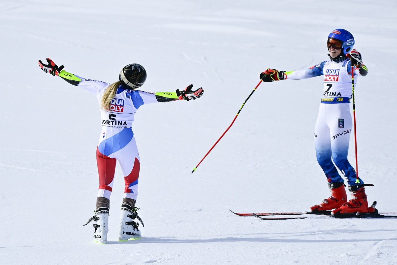 Lara Gut-Behrami of Switzerland, left, celebrates his first place, next to Mikaela Shiffrin of the United States, right, in the finish area during the second run of the women&#039;s Giant Slalom race  ...