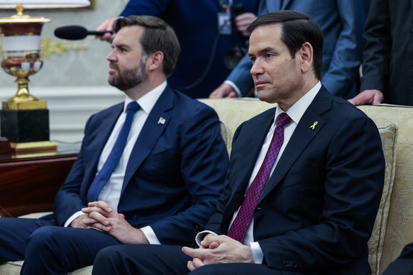 epa12437905 US Secretary of State Marco Rubio (R), and US Vice president JD Vance (L) look on as President Donald Trump meets with Canadian Prime Minister Mark Carney in the Oval Office of the White H ...