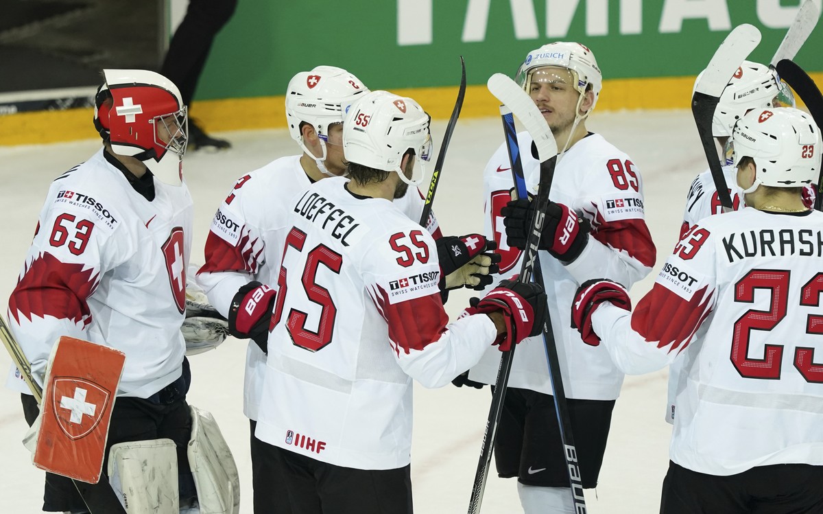 Switzerlan's team players celebrate victory after the Ice Hockey World Championship group A match between the Belarus and Switzerland at the Olympic Sports Center in Riga, Latvia, Sunday May 30,  ...