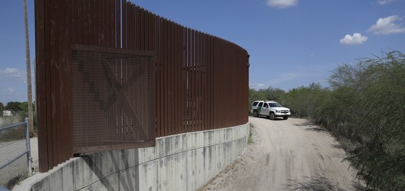 FILE - In this Aug. 11, 2017, file photo, a U.S. Customs and Border Patrol vehicle passes along a section of border levee wall in Hidalgo, Texas. The Department of Homeland Security has issued another ...