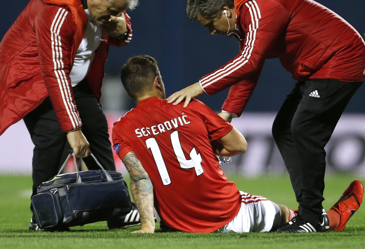 Benfica's Haris Seferovic is assisted after injuring himself during the Europa League round of 16, first leg soccer match between Dinamo Zagreb and Benfica at Maksimir Stadium in Zagreb, Croatia, ...