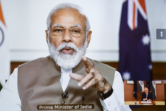 epa08464177 Indian Prime Minister Narendra Modi is seen on a conference screen during the 2020 Virtual Leaders Summit between Australia and India at Parliament House in Canberra, Australia, 04 June 20 ...
