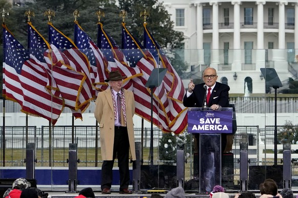 FILE - In this Jan. 6, 2021 file photo, Chapman University law professor John Eastman stands at left as former New York Mayor Rudolph Giuliani speaks in Washington at a rally in support of President D ...