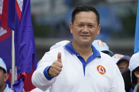 Hun Manet, a son of Cambodia Prime Minister Hun Sen, shows a thumbs-up as he leads a procession to mark the end of an election campaign of Cambodian People&#039;s Party, in Phnom Penh, Cambodia, Frida ...