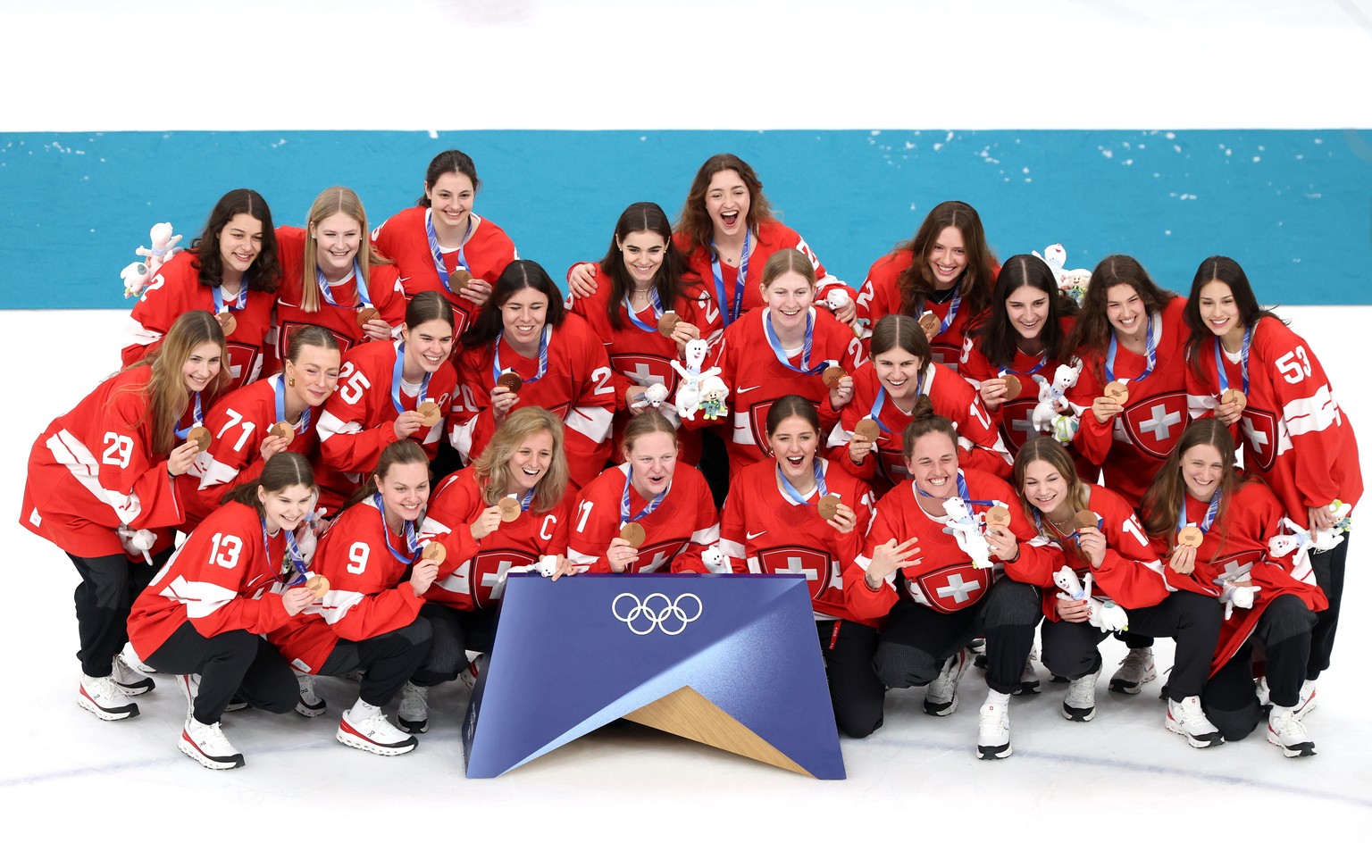 epa12759846 Bronze medalists Team Switzerland celebrate during the medal ceremony for the Women's Ice Hockey at the Milano Cortina 2026 Winter Olympic Games, in Milan, Italy, 19 February 2026. EP ...