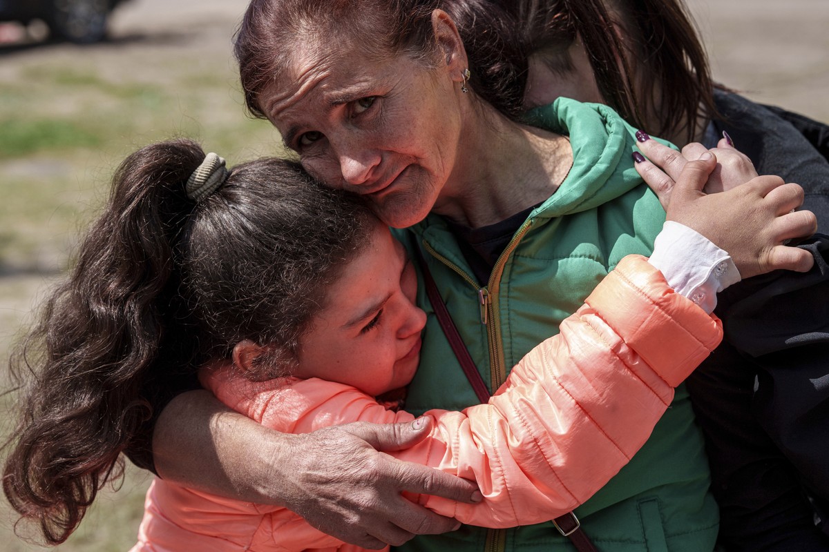 Khrystyna Pyimak, 11, hugs her mother Oksana Velychko, 42, after evacuation from Vovchansk, Ukraine, Sunday, May 12, 2024. Her husband was killed in their house after a Russian airstrike on the city.  ...