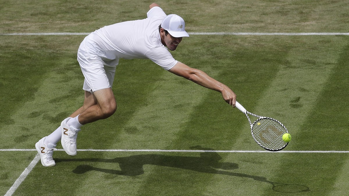 United States'Reilly Opelka returns to Switzerland's Stan Wawrinka in a Men's singles match during day three of the Wimbledon Tennis Championships in London, Wednesday, July 3, 2019. (A ...