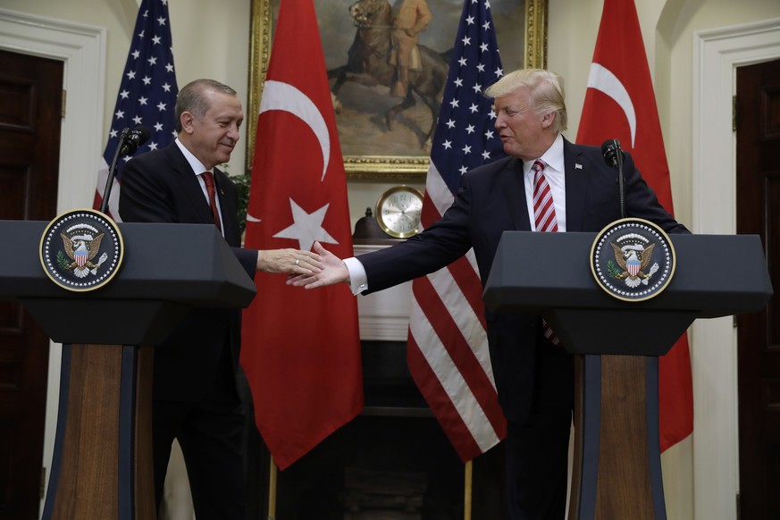 President Donald Trump reaches to shake hands with Turkish President Recep Tayyip Erdogan in the Roosevelt Room of the White House in Washington, Tuesday, May 16, 2017, where they made statements. (AP ...