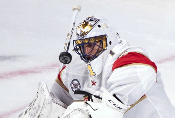 Florida Panthers goaltender Roberto Luongo eyes the puck as he makes a save against the Montreal Canadiens during the second period of an NHL hockey preseason game Wednesday, Sept. 19, 2018, in Montre ...