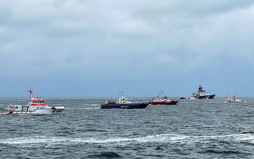 epa10936528 A photo made available by the DGzRS shows rescue ships at the scene of a ship collision accident near the island of Helgoland, Germany, October 24, 2023. According to the Central Com ...